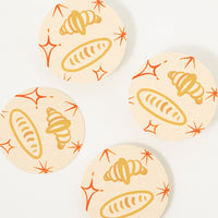 Croissants: Paper coasters with bread and croissant print.