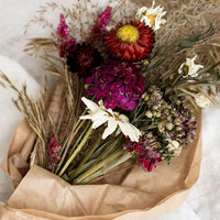 1: A dried flower bouquet in dark red and pink tones.