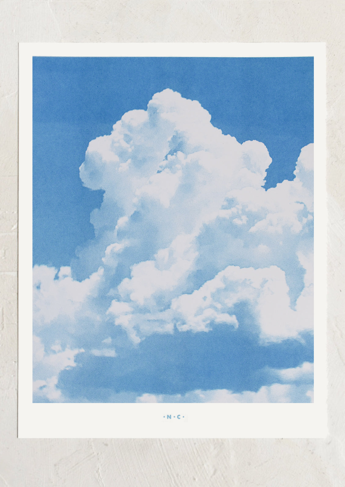 Large fluffy white cloud against a blue sky with a white border.