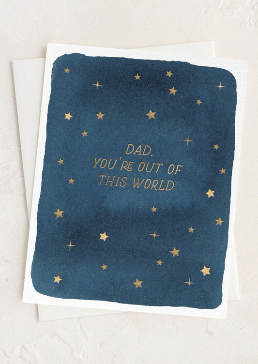 Greeting card with star pattern and text 'Dad, you're out of this world' on a blue background.