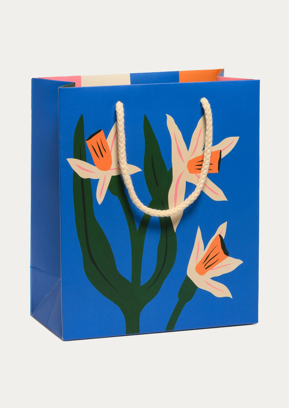 Cobalt blue gift bag with floral design.