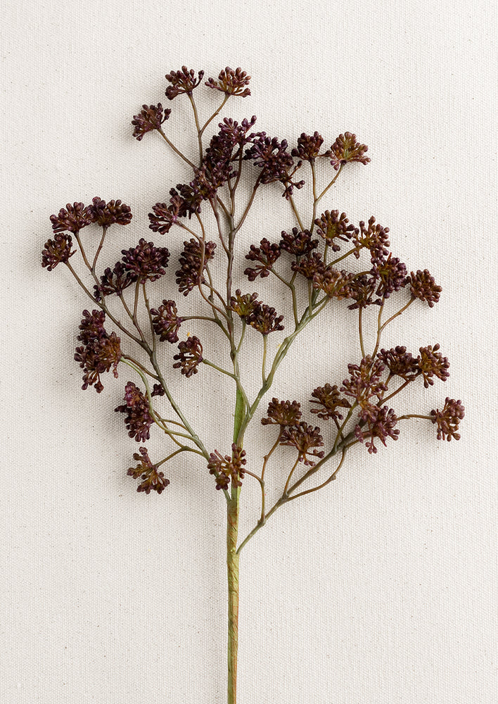A faux sedum branch with dainty buds in aubergine.