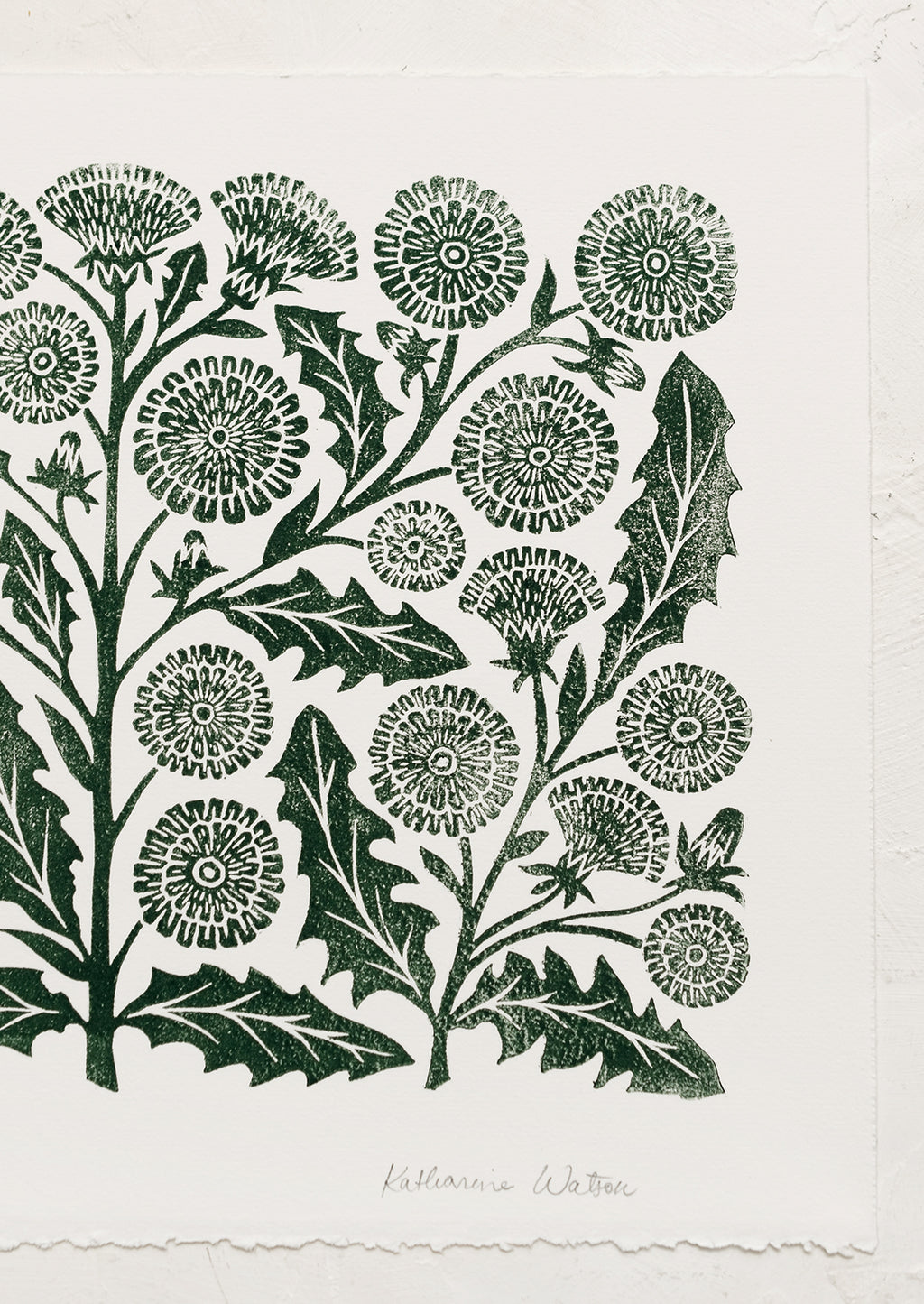 2: A woodblock print of dandelion flowers in dark green ink.