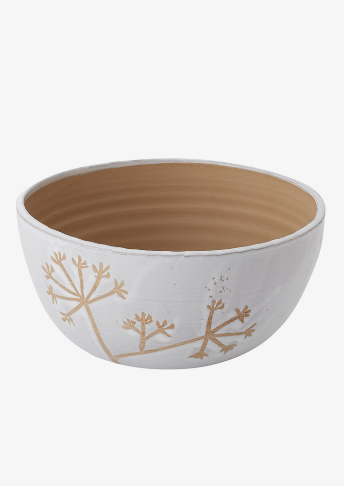 White and brown ceramic bowl with flower motif.