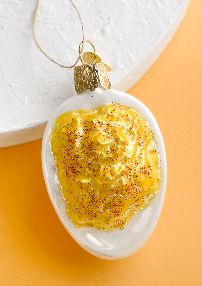 A glass ornament of a deviled egg.