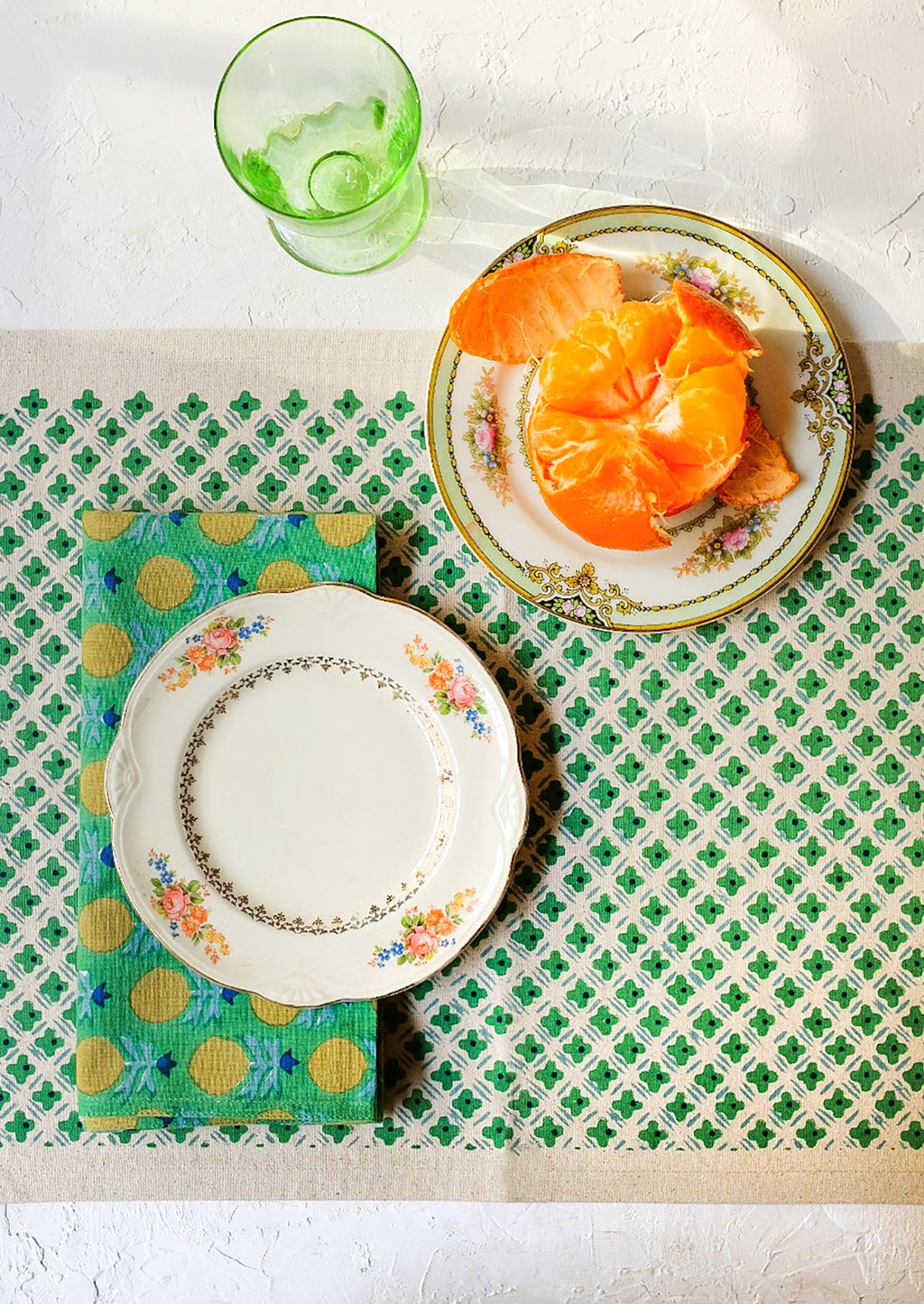 2: A placemat as part of a green themed table setting.