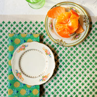 2: A placemat as part of a green themed table setting.