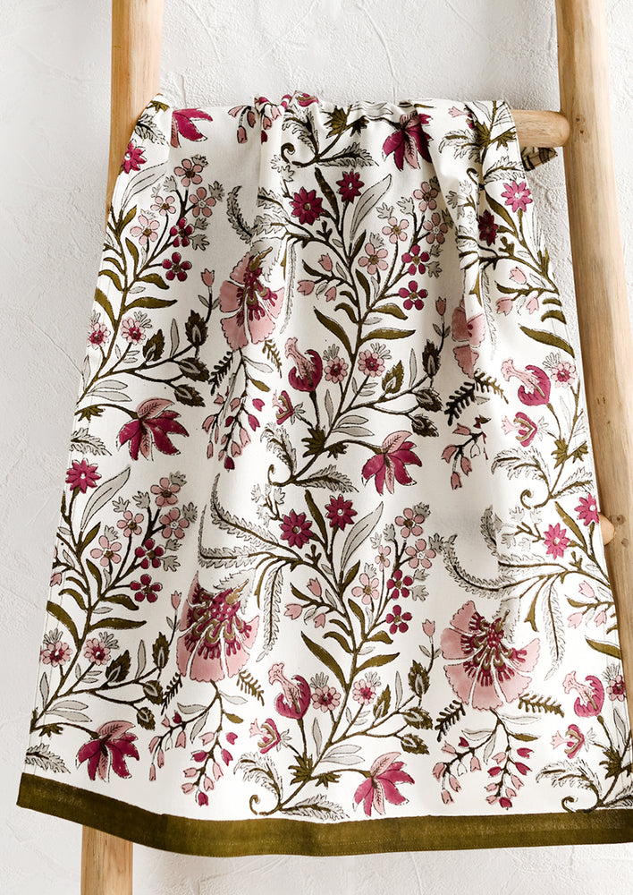 1: A cotton tea towel in block printed floral pattern in maroon, mauve and olive green.