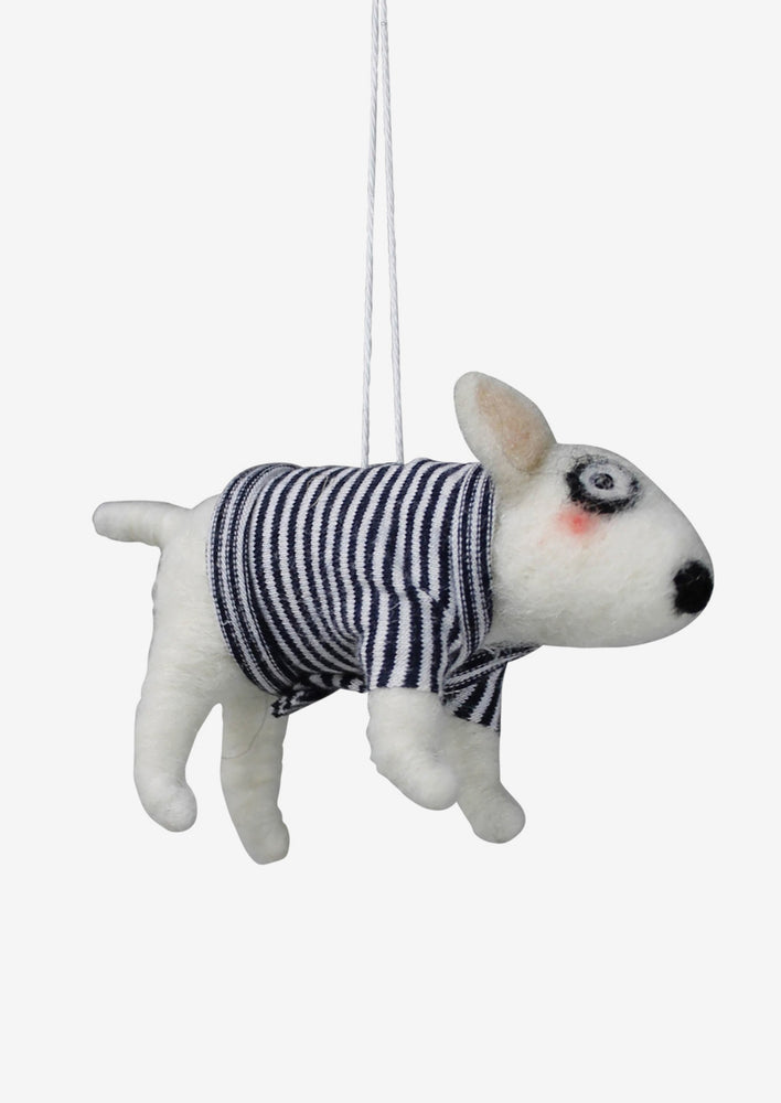 A felted holiday ornament of a white dog in a navy striped sweater.
