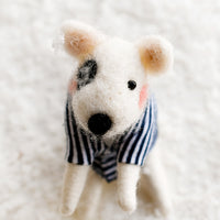 1: A felted holiday ornament of a white dog in a navy striped sweater.