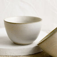 2: Two small ceramic bowls in natural speckle glazes.