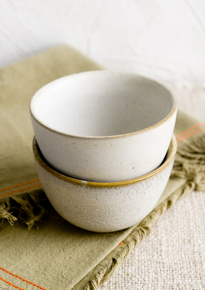 1: Two small ceramic bowls in natural speckle glazes.
