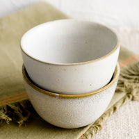 1: Two small ceramic bowls in natural speckle glazes.