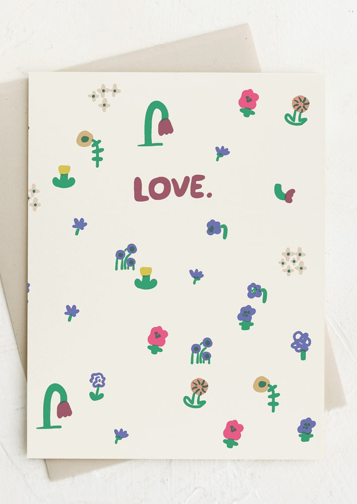 A card with playful doodle print reading "LOVE."
