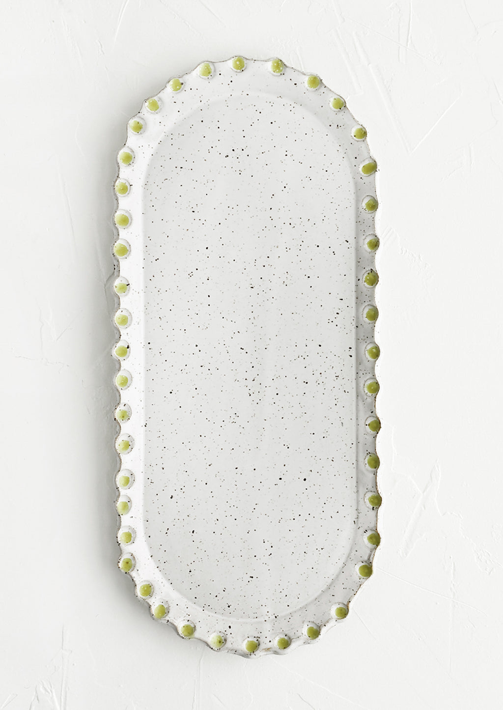 Glossy White Speckle / Apple Green: An oblong, oval shaped ceramic platter with green dot imprint border.