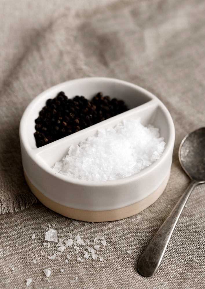 1: A divided white dish for salt and pepper.