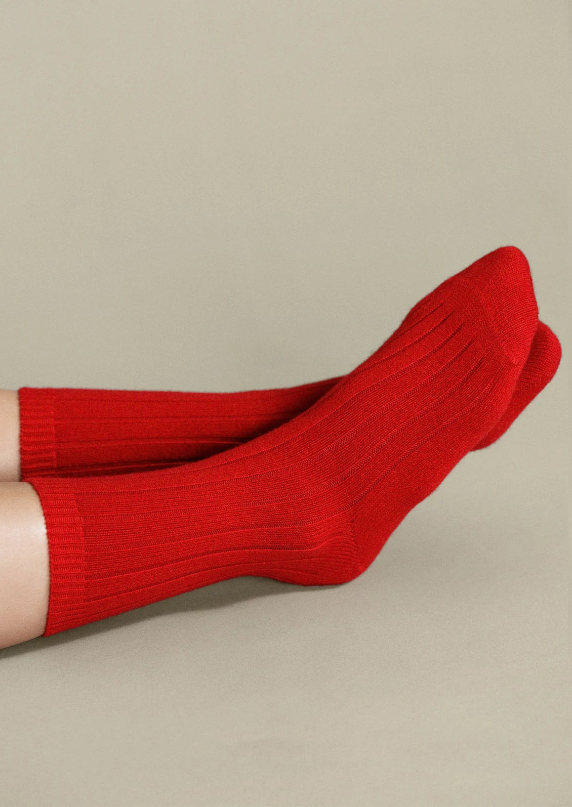 A person wearing ribbed red cashmere socks.