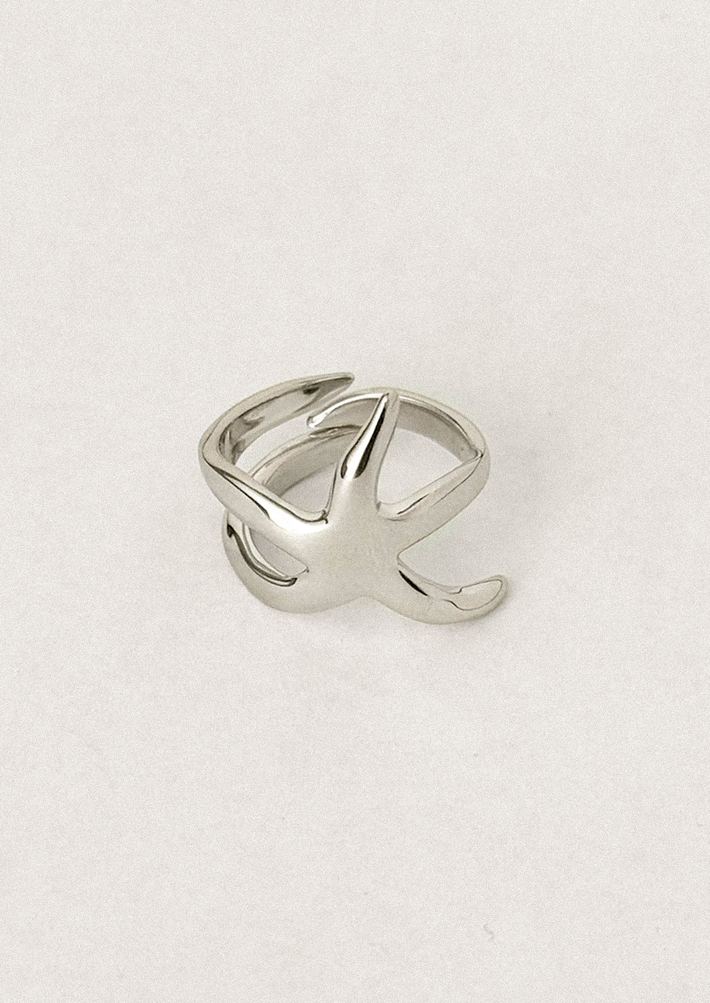 A sterling silver ring with asymmetrical star shape.