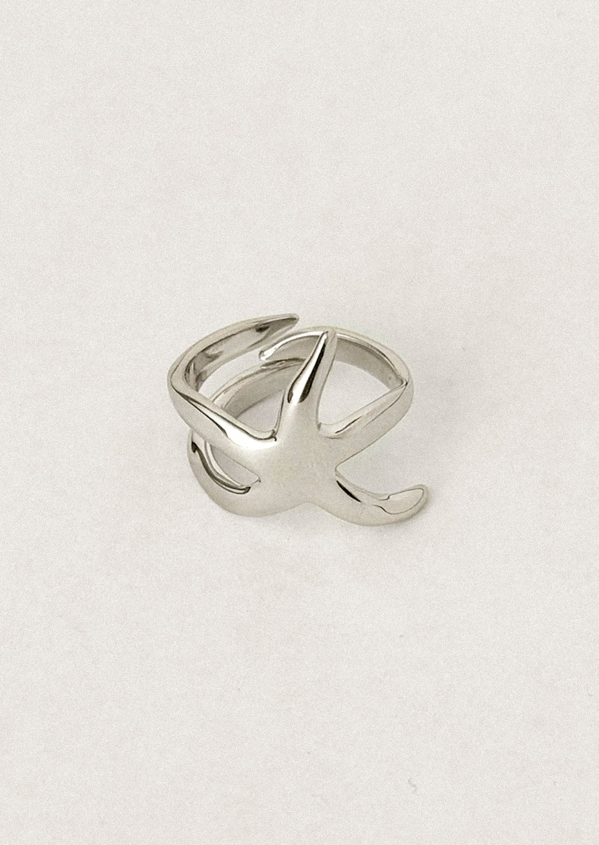 A sterling silver ring with asymmetrical star shape.