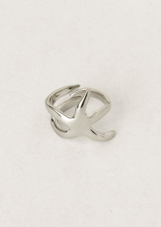 A sterling silver ring with asymmetrical star shape.
