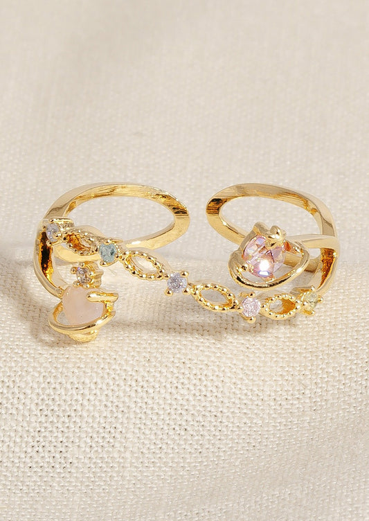 A ring with pastel colored crystals and planet design.