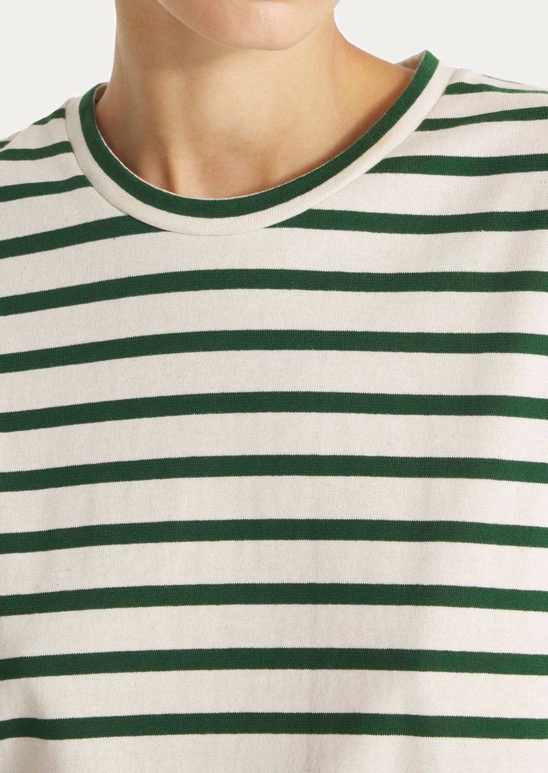 Close-up of a person wearing a green and white striped shirt.
