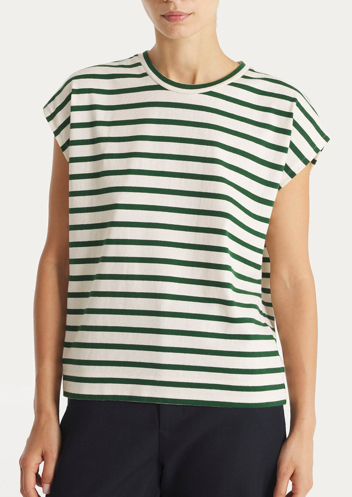 Person wearing a green and white striped shirt on a plain background