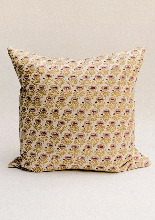 A block printed throw pillow with chartreuse and pink floral pattern.