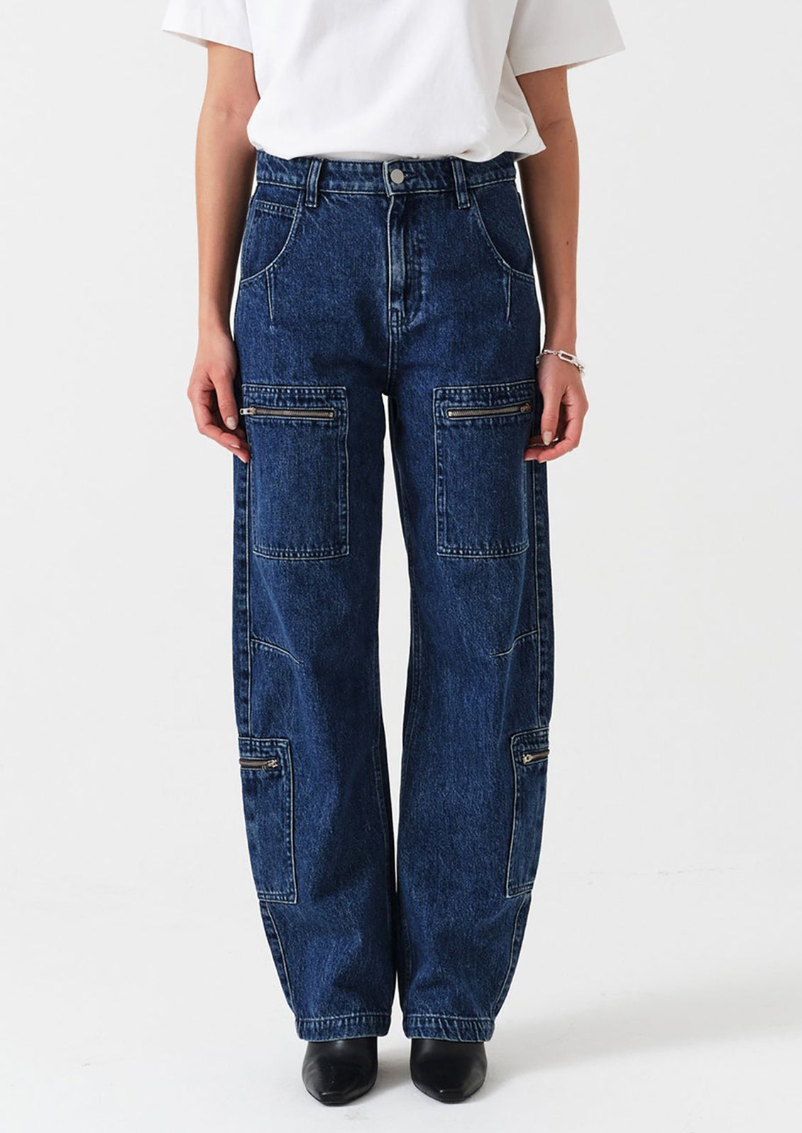 Person wearing blue jeans and a white shirt on a white background