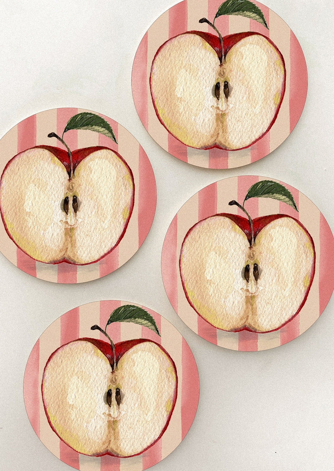 A set of coasters with apple core print.