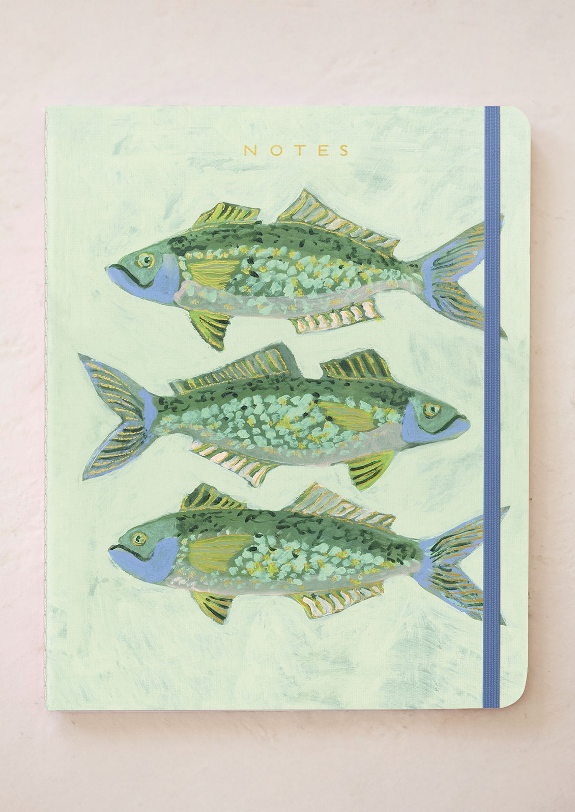 Notebook with fish illustrations on a light green background