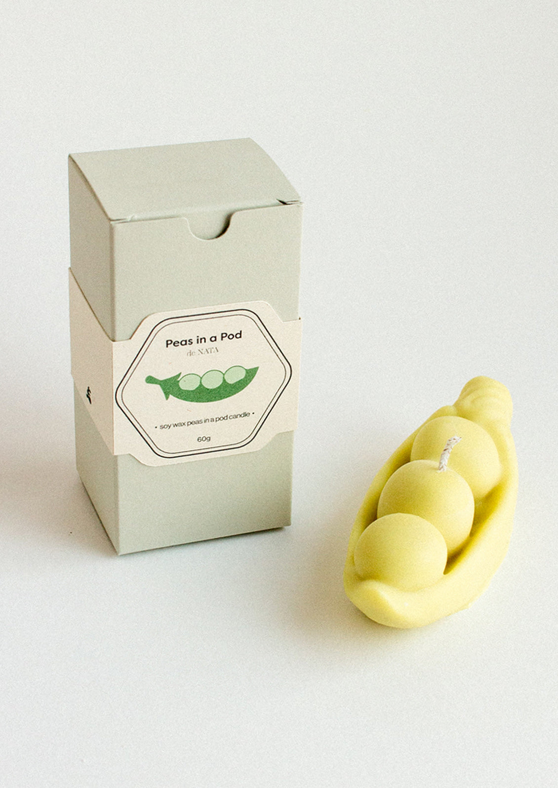 A decorative candle shaped like a peapod.