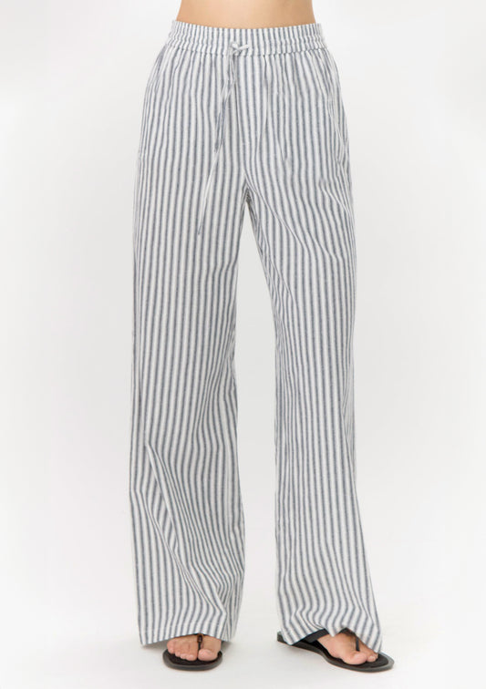 Striped pants worn by a person on a white background