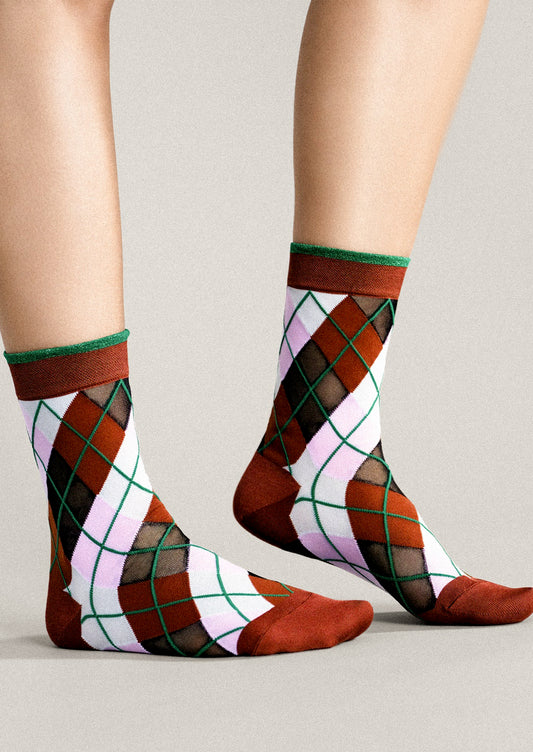Colorful argyle patterned socks on a neutral background