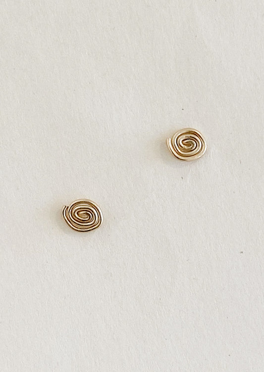 A pair of gold stud earrings with organic swirl shape.