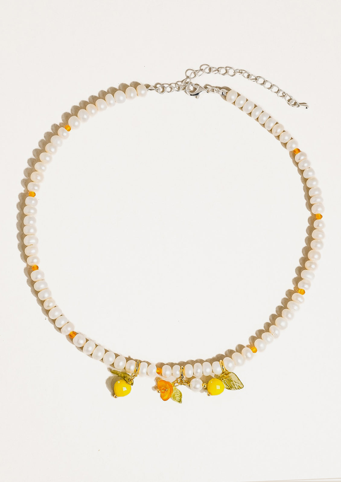 A beaded pearl necklace with lemon charms.
