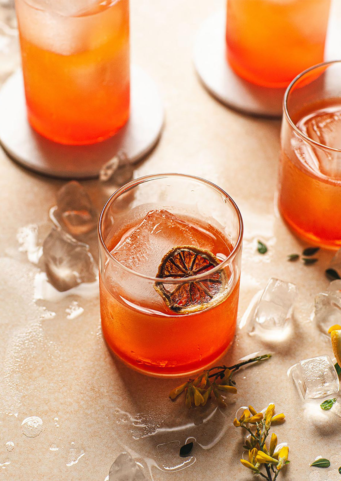 A clear double old fashioned glass with cocktail.