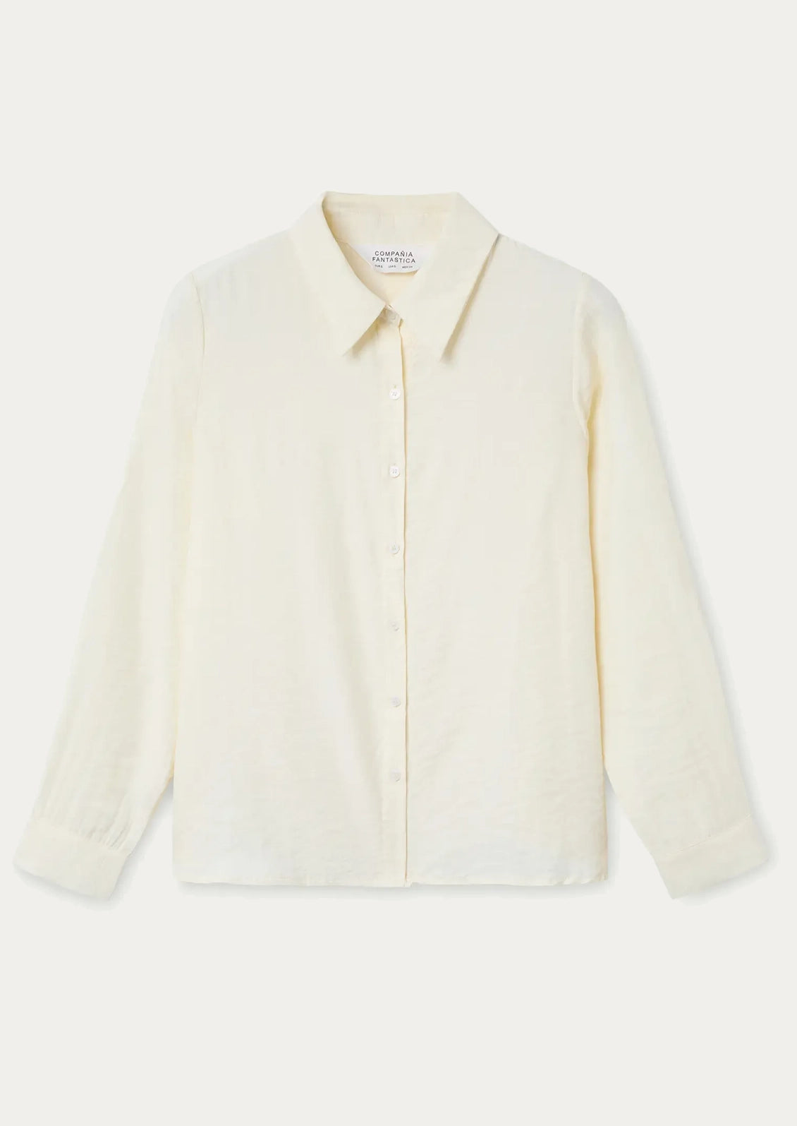 A cream button up collared shirt.