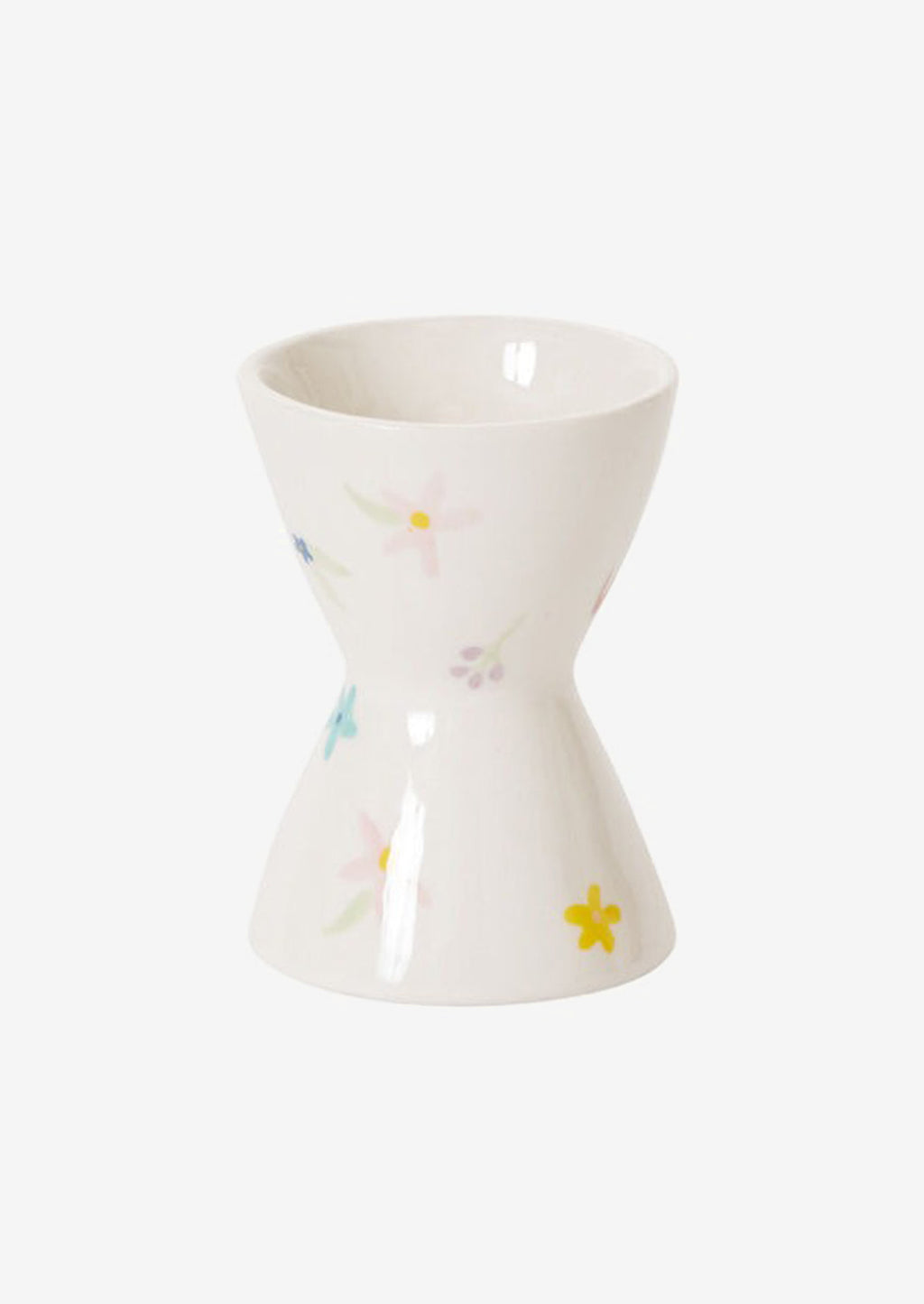 1: A white egg cup with pastel floral pattern.