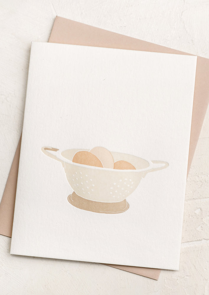1: A letterpressed greeting card with image of eggs in colander.