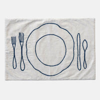 2: An off-white linen-cotton placemat with navy blue plate and silverware embroidery.