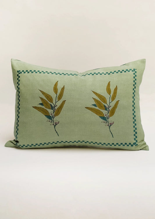 A lumbar pillow in green with eucalyptus motif.