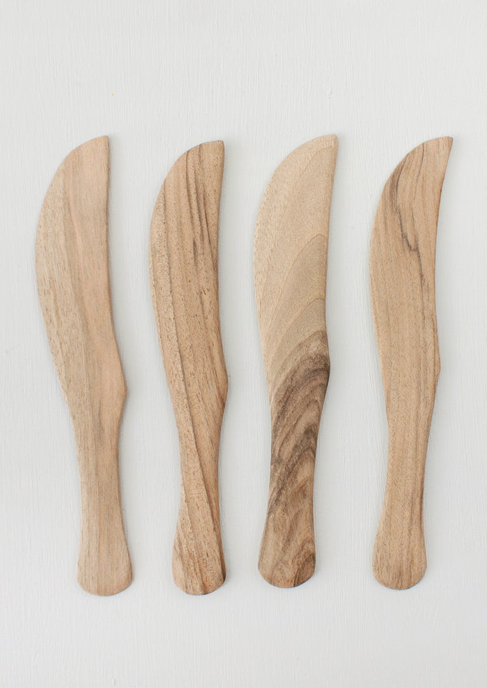 Assorted walnut wood cheese knives.