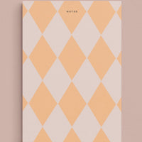Lavender / Creamsicle Multi: A diamond print notepad in peach and blush reading "NOTED" at the top.