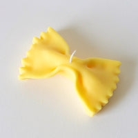 1: A candle in the shape of a piece of farfalle pasta.