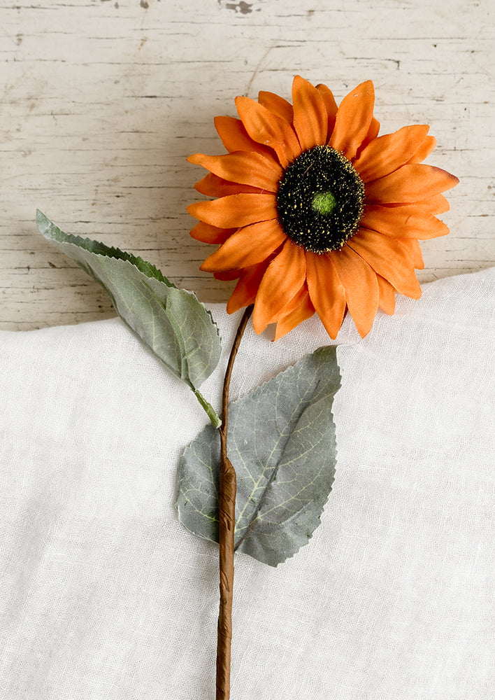 1: A faux orange sunflower stem.