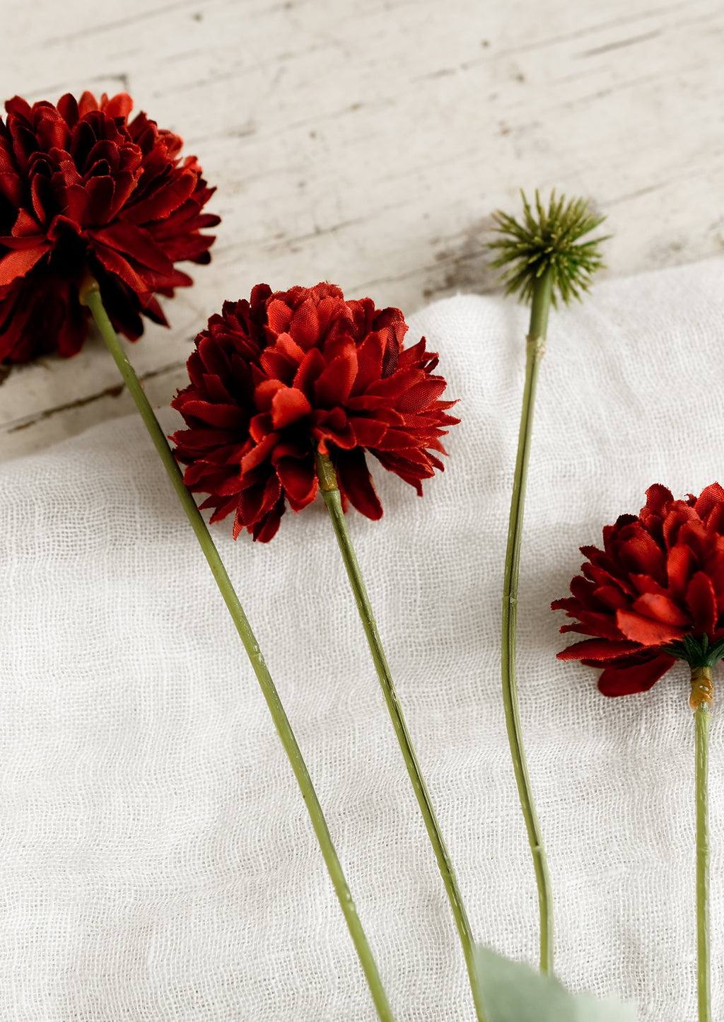 2: An artificial flower spray in the style of a red mum.