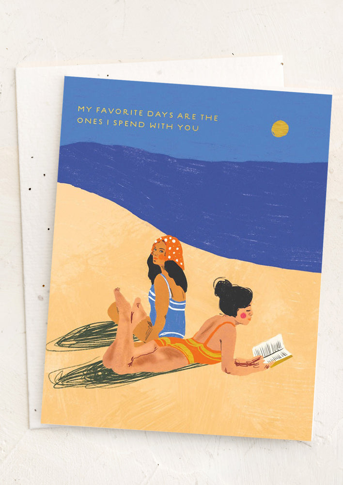 A card with image of two women laying on a beach' text reads, "my favorite days are the ones I spend with you".