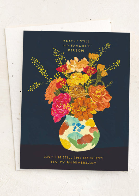 Greeting card with colorful floral design and anniversary message on a white background