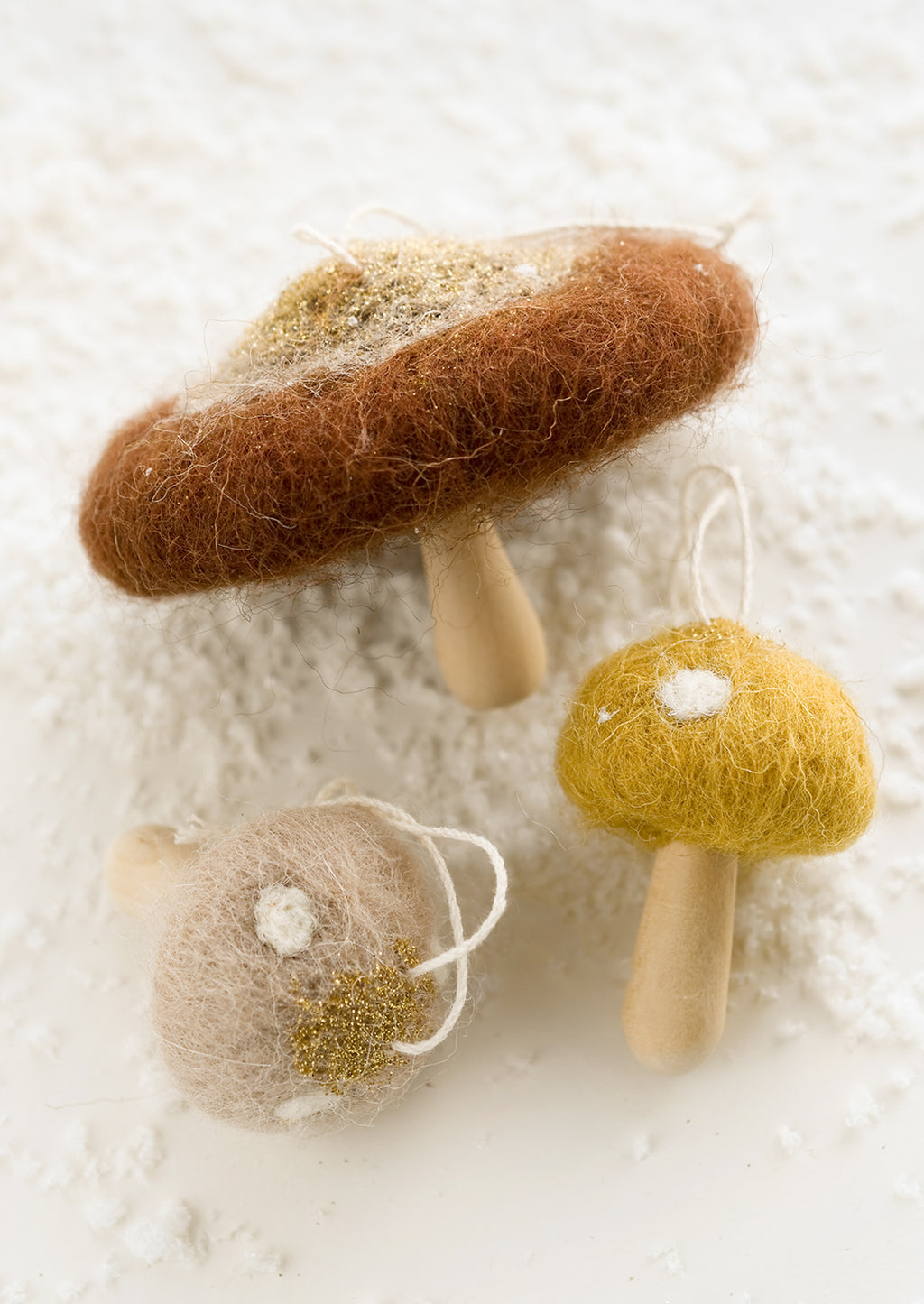 2: Mushroom ornaments in assorted colors with felted tops and wooden "stumps".